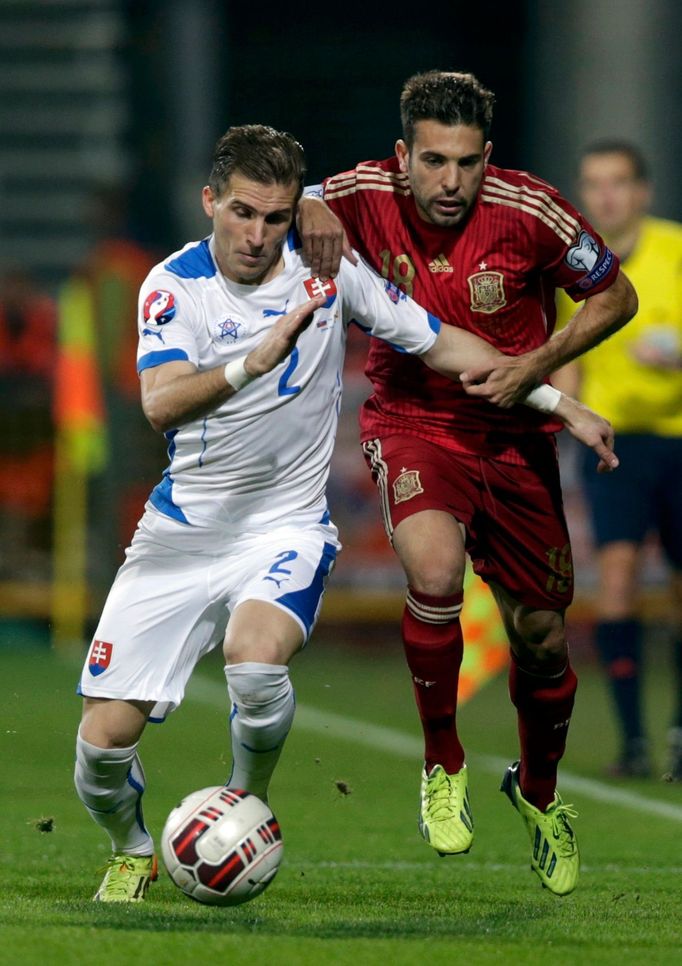 Alba of Spain is challenged by Pekarik of Slovakia during their Euro 2016 qualification soccer match at the MSK stadium in Zilina