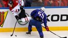 Nathan MacKinnon of Canada (L) is knocked to the ice by Jonathan Janil of France (R) during the first period of their men's ice hockey World Championship Group A game at