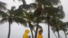 Ulrike Lehmann, from Berlin, Germany (L) and her friend, a Key West resident only identified as Ginger, walk along the beach taking photographs as Tropical Storm Isaac moves over Key West, FL August 26, 2012. REUTERS/Andrew Innerarity (UNITED STATES - Tags: ENVIRONMENT DISASTER) Published: Srp. 26, 2012, 7:47 odp.