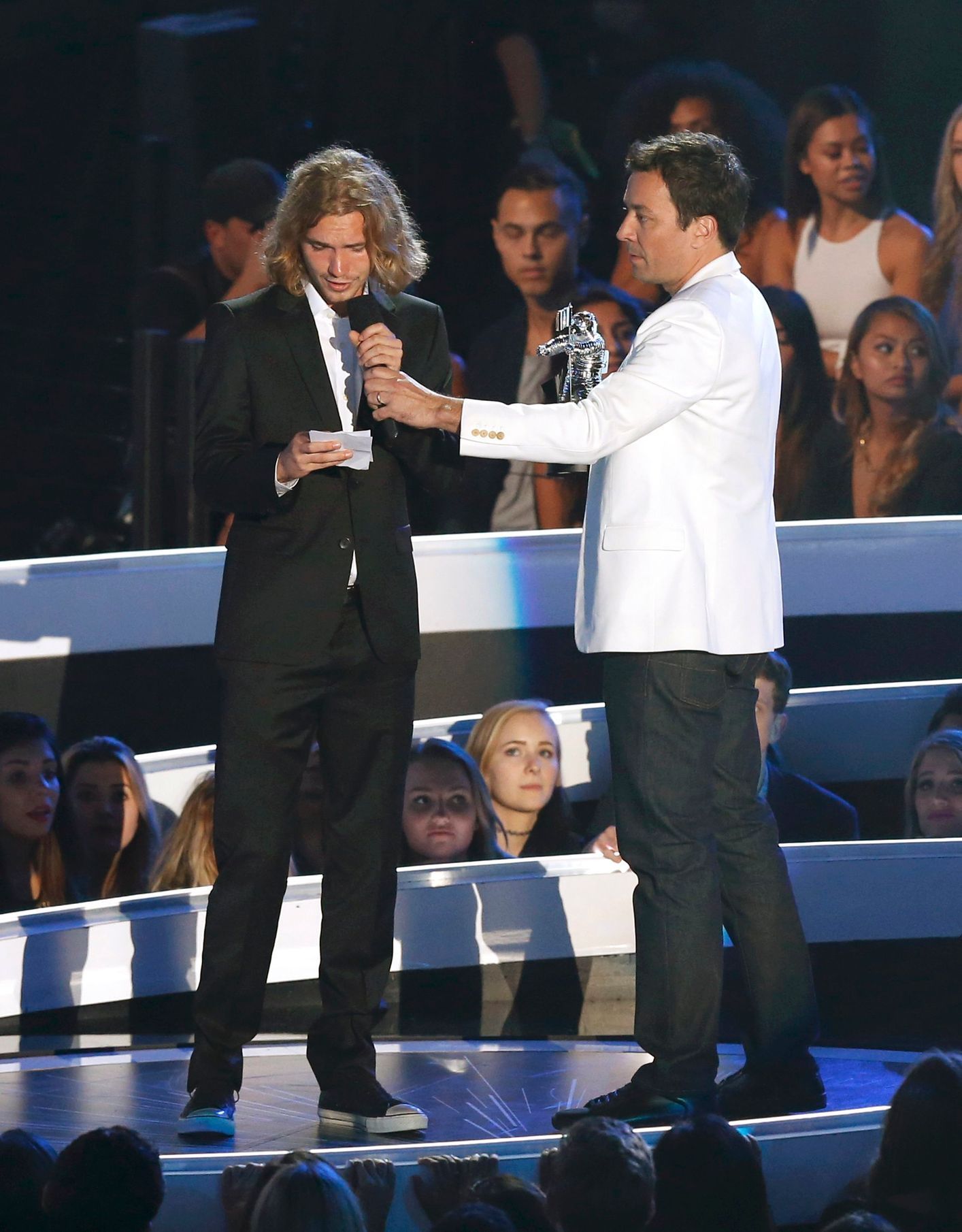 A spokesperson named Jesse accepts the award for Video of the Year for Miley Cyrus' &quot;Wrecking Ball&quot; as presenter Jimmy Fallon waits during the 2014 MTV Video Music Awards in Inglewood