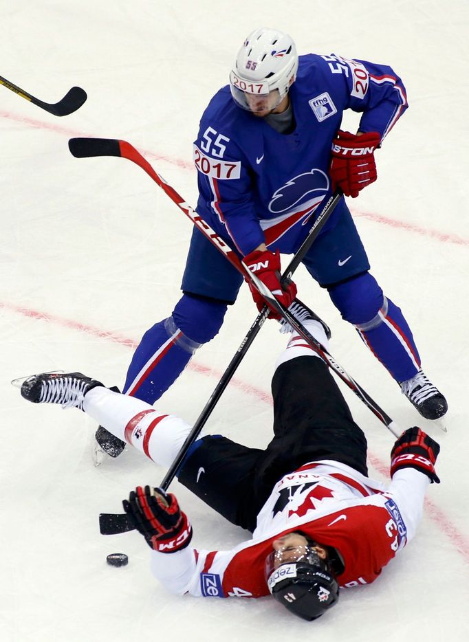 France's Jonathan Janil (55) knocks Canada's Nazem Kadri to the ice during the third period of their men's ice hockey World Championship Group A game at Chizhovka Arena i