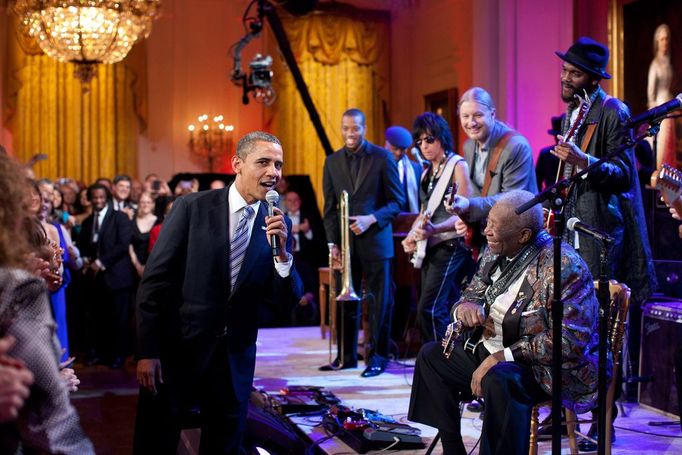 "Egged on by B.B. King, at right, the President joins in singing 'Sweet Home Chicago' during the 'In Performance at the White House: Red, White and Blues' concert in the East Room. Participants include, from left: Troy 'Trombone Shorty' Andrews, Jeff Beck, Derek Trucks, B.B. King, and Gary Clark, Jr."