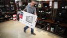 Kerim Sacak, a 29 year-old sales and delivery person, carries an LCD screen in Tehnomax computer shop in Zenica, May 11, 2012. Sacak studied for four years at Sarajevo University where he received a police degree. For the last four years he has tried to find a job as a police officer but has been working in sales and delivery for three years.