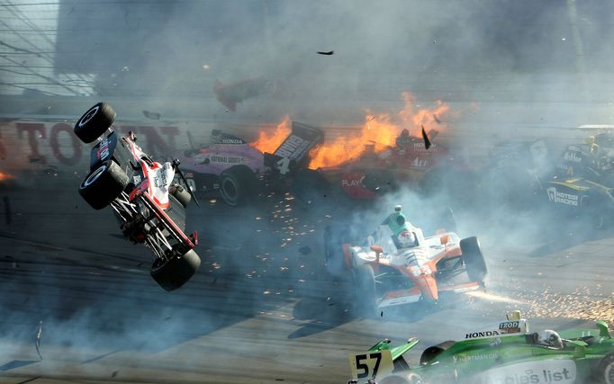 The race car of driver Will Power (L) goes airborne during the IZOD IndyCar World Championship race at the Las Vegas Motor Speedway in Las Vegas, Nevada, U.S., October 16