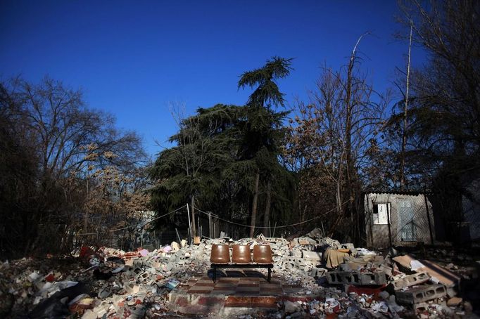 A set of chairs remains among the debris of a former house that was demolished at the Spanish gypsy settlement of Puerta de Hierro outside Madrid January 4, 2012. Fifty-four families have been living in Puerta de Hierro, on the banks of the Manzanares river for over 50 years. Since the summer of 2010, the community has been subject to evictions on the grounds that the dwellings are illegal. Families whose houses have been demolished, move in with relatives whose houses still remain while the debris keeps piling up around them as more demolitions take place. Picture taken January 4, 2012. REUTERS/Susana Vera (SPAIN - Tags: SOCIETY) ATTENTION EDITORS - PICTURE 31 OF 31 FOR PACKAGE 'GYPSY SITE DEMOLISHED' SEARCH 'GYPSY SITE' FOR ALL IMAGES Published: Lis. 5, 2012, 4:13 odp.