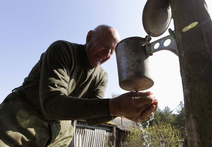 Villager Shamianok washes his face at house in abandoned village of Tulgovichi