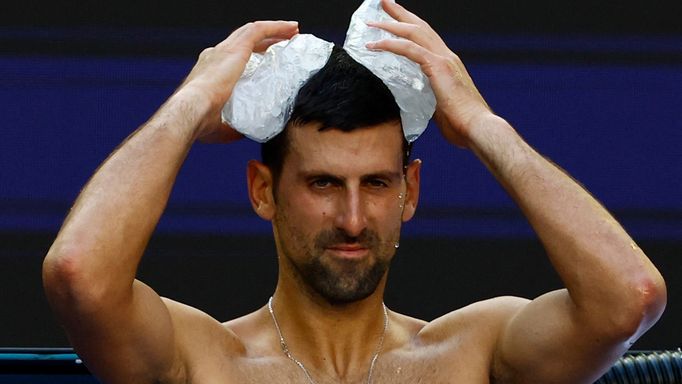 Tennis - Australian Open - Melbourne Park, Melbourne, Australia - January 23, 2024 Serbia's Novak Djokovic holds ice packs on his head during his quarter final match agai