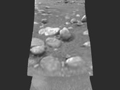 Povrch Titanu jak jej po přistání zabrala sonda Huygens.