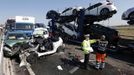 A police officer and a rescue worker talk amongst the wreckage of some of the 100 vehicles involved in multiple collisions, which took place in dense fog during the morning rush hour, on the Sheppey Bridge in Kent, east of London, September 5, 2013. Eight people were seriously injured and dozens hurt in the multiple crashes.