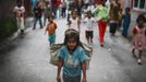 Children follow Shivani Choudhary, 7, a street performer while she returns after finishing her street performance in Kathmandu August 15, 2012. Shivani and her brothers Drumpal and Gchan, who came to Kathmandu from India 5 years ago, earn their living by performing tricks on the streets of Kathmandu. According to Drumpal, Shivani's older brother, they earn around $10 a day by performing tricks, which is not enough to feed their 10-member family living together in a small hut without a proper toilet or any basic needs. REUTERS/Navesh Chitrakar (NEPAL - Tags: SOCIETY POVERTY IMMIGRATION) Published: Srp. 15, 2012, 4:33 odp.