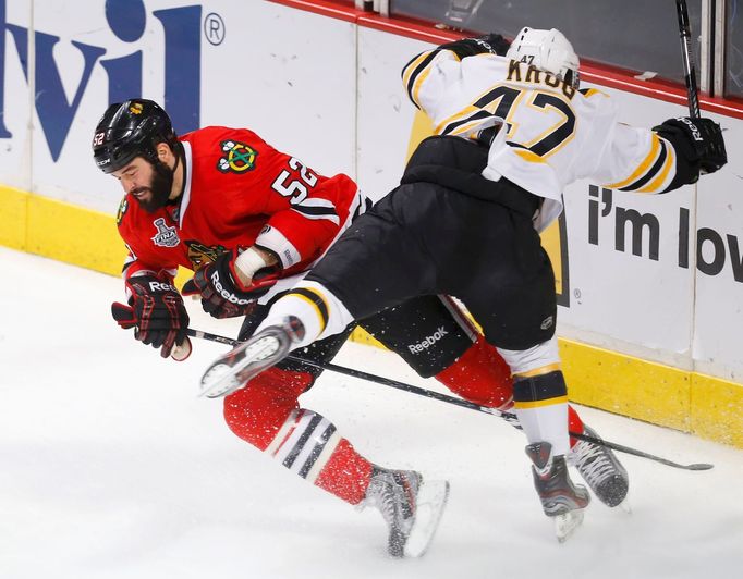 Chicago Blackhawks' Brandon Bollig (L) collides with Boston Bruins' Torey Krug during the first period in Game 2 of their NHL Stanley Cup Finals hockey series in Chicago,