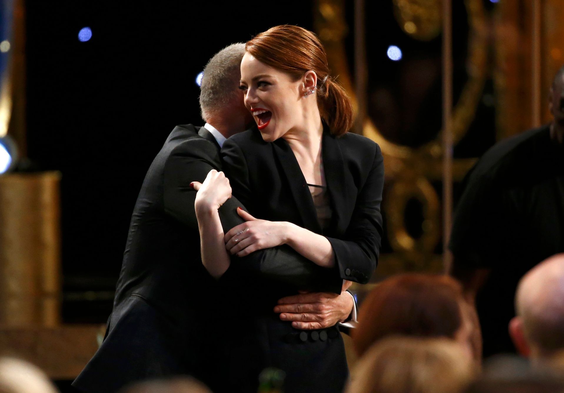 Actress Stone of the film &quot;Birdman&quot; is hugged by Keaton as they head to the stage to accept the award for Outstanding Performance by a Cast in a Motion Picture at the 21st annual Screen Acto