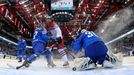 Italy's goalie Daniel Belissimo (R) saves a shot of Jiri Novotny of the Czech Republic (C) during their men's ice hockey World Championship Group A game at Chizhovka Aren