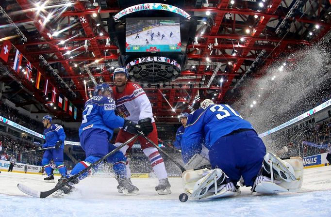 Italy's goalie Daniel Belissimo (R) saves a shot of Jiri Novotny of the Czech Republic (C) during their men's ice hockey World Championship Group A game at Chizhovka Aren