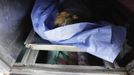 The dead body of a man who died of gunshot wounds is seen at the morgue of a local hospital in San Pedro Sula March 20, 2013. San Pedro Sula, the country's second largest city after Tegucigalpa, has a homicide rate of 169 per 100,000 people and was named the world's most violent city for a second year in a row. Lax laws allow civilians to own up to five personal guns. Arms trafficking has flooded the country with nearly 70% illegal firearms. 83.4% of homicides are by firearms, compared to 60% in the United States. Picture taken March 20, 2013. REUTERS/Jorge Cabrera (HONDURAS - Tags: CRIME LAW CIVIL UNREST HEALTH) ATTENTION EDITORS: PICTURE 35 OF 39 FOR PACKAGE 'GUN CULTURE - HONDURAS' SEARCH 'HONDURAS GUN' FOR ALL IMAGES Published: Dub. 5, 2013, 11:15 dop.