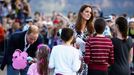 Britain's Prince William and his wife Catherine, the Duchess of Cambridge, receive gifts from a group of children during a tour of Echo Point in the Blue Mountains town o