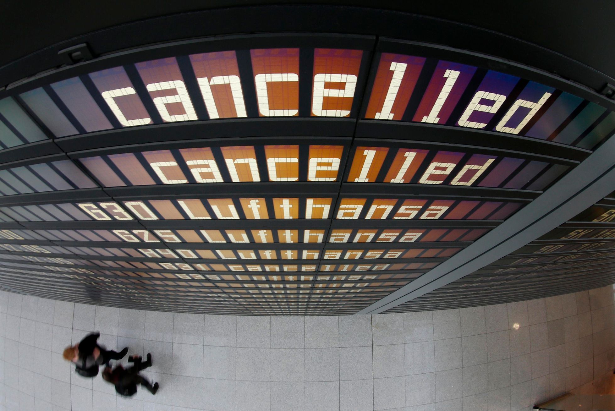 Cancelled flights by German air carrier Lufthansa are pictured on flight schedule board at Munich's airport