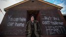 Linda Restaino poses for a photograph in front of a message written by her son on the boarded up back wall of her property which was flooded during Hurricane Sandy in New Dorp Beach, Staten Island November 14, 2012. Restaino, who has lived at the property for 35 years, is now hoping to leave Staten Island. Picture taken November 14, 2012 REUTERS/Mike Segar (UNITED STATES - Tags: DISASTER ENVIRONMENT) ATTENTION EDITORS PICTURE 19 OF 19 FOR PACKAGE 'SURVIVING SANDY' SEARCH 'SEGAR SANDY' FOR ALL PICTURES Published: Lis. 20, 2012, 3:31 odp.