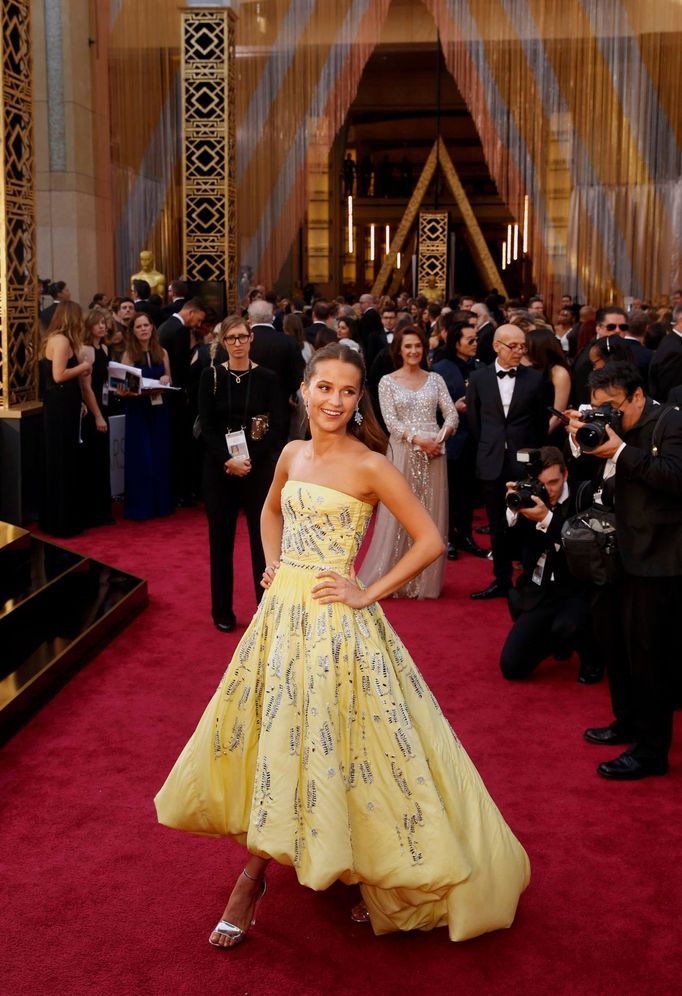 Alicia Vikander, nominated for Best Supporting Actress in &quot;The Danish Girl,&quot; wears a yellow Louis Vuitton gown as she arrives at the 88th Academy Awards in Holl