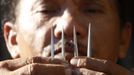 Ruben Enaje, 52, who will portray as Jesus Christ for the 27th time, shows three-inch nail which he will use on a Good Friday crucifixion re-enactment in San Pedro Cutud town, Pampanga province, north of Manila March 29, 2013. The Roman Catholic church frowns on the gory spectacle held in the Philippine village of Cutud every Good Friday but that does nothing to deter the faithful from emulating the suffering of Christ and taking a painful route to penitence. Holy Week is celebrated in many Christian traditions during the week before Easter. REUTERS/Romeo Ranoco (PHILIPPINES - Tags: POLITICS RELIGION SOCIETY TPX IMAGES OF THE DAY) Published: Bře. 29, 2013, 4:12 dop.