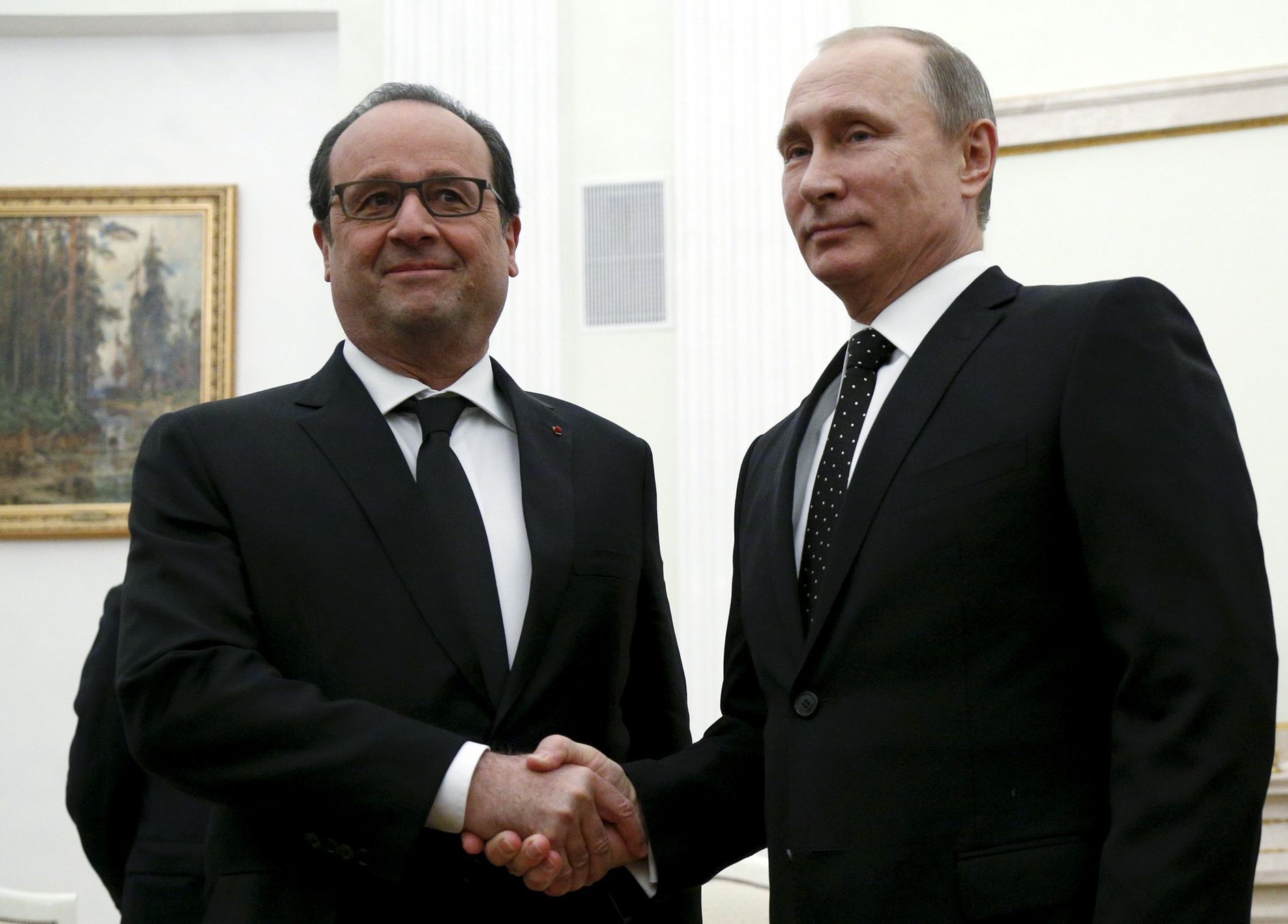 Russia's President Vladimir Putin shakes hands with his French counterpart Francois Hollande during a meeting at the Kremlin in Moscow