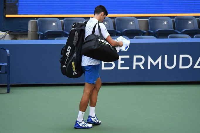 Sep 6, 2020; Flushing Meadows, New York, USA; Novak Djokovic of Serbia leaves the court after being defaulted for striking a lines person with a ball against Pablo Carren