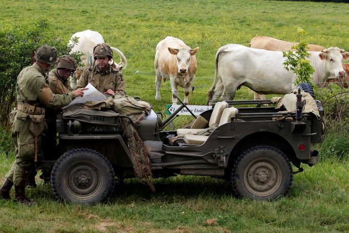 Few days before the 75th anniversary of the allied landings on D-Day, history enthusiasts read a map on a vintage jeep during a re-enactment of D-Day landings