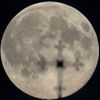 The supermoon is seen behind a cross of an Orthodox church in Minsk