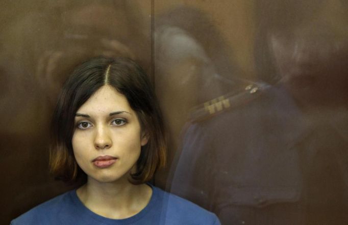 A member of the female punk band &quot;Pussy Riot&quot; Nadezhda Tolokonnikova sits in a glass-walled cage during a court hearing in Moscow, August 17, 2012. A Russian ju