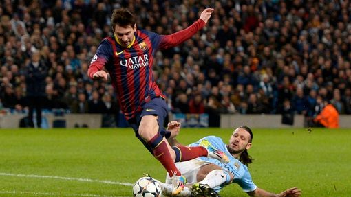 Manchester City's Martin Demichelis fouls Barcelona's Lionel Messi to concede a penalty during their Champions League round of 16 first leg soccer match at the Etihad Sta