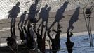 Passers-by are reflected in mirror panels designed by British architect Norman Foster as they walk at the Old Harbour in Marseille February 21, 2013. The installation will be inaugurated on March 2. REUTERS/Jean-Paul Pelissier (FRANCE - Tags: SOCIETY)