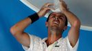 Roger-Vasselin of France holds a bag of ice to his head during a break in play in his men's singles match against Anderson of South Africa at Australian Open 2014 tennis