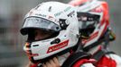 Ferrari Formula One driver Sebastian Vettel of Germany (L) walks ahead of team mate Kimi Raikkonen of Finland after the qualifying session of the Australian F1 Grand Prix