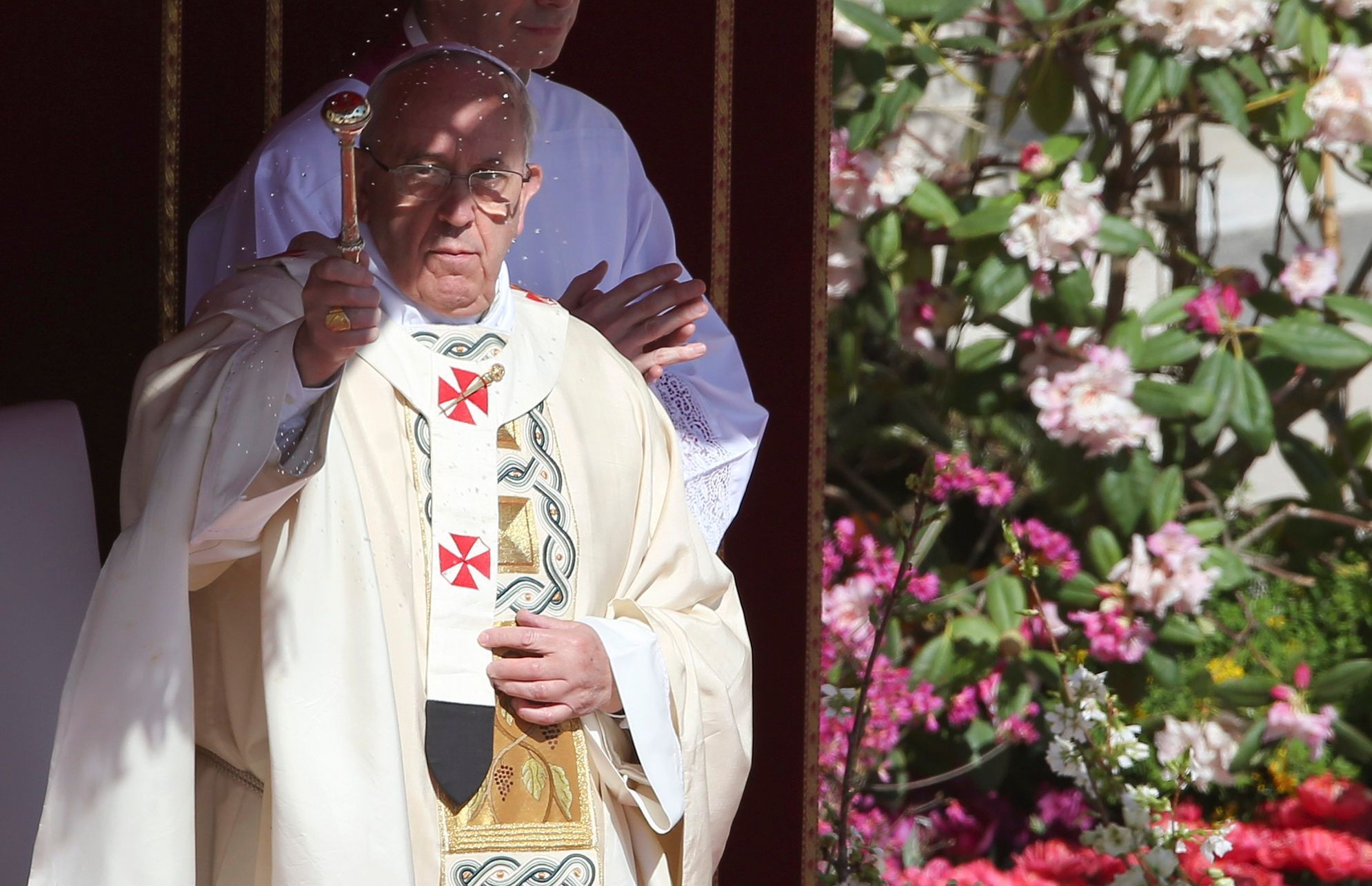 Pope Francis sprinkles holy water as he leads the Easter mass in Saint Peter's Square at the Vatican