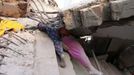 ATTENTION EDITORS - VISUAL COVERAGE OF SCENES OF DEATH OR INJURY Bodies of garment workers are seen among the rubble in the Rana Plaza building which collapsed, in Savar, 30 km (19 miles) outside Dhaka April 24, 2013. A block housing garment factories and shops collapsed in Bangladesh on Wednesday, killing nearly 100 people and injuring more than a thousand, officials said.REUTERS/Andrew Biraj (BANGLADESH - Tags: DISASTER BUSINESS) TEMPLATE OUT Published: Dub. 24, 2013, 3:50 odp.