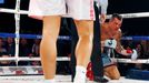 World champion Gennadiy Golovkin of Kazakhstan (L) looks at Martin Murray of England (R), after knocking him down, during the WBA-WBC-IBO Middleweight World Championship