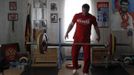 Olympic silver medallist weightlifter Dmitry Klokov drops weights during training at his father's house in the village of Sinkovo