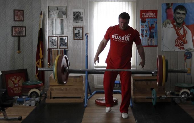 Olympic silver medallist weightlifter Dmitry Klokov drops weights during training at his father's house in the village of Sinkovo