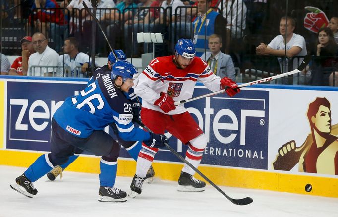 Finland's Jarkko Immonen (L) and Michal Jordan of the Czech Republic chase the puck during their men's ice hockey World Championship semi-final game at Minsk Arena in Min