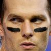 New England Patriots quarterback Tom Brady takes his helmet off during warm-ups ahead of the start of the NFL Super Bowl XLIX football game against the Seattle Seahawks in Glendale