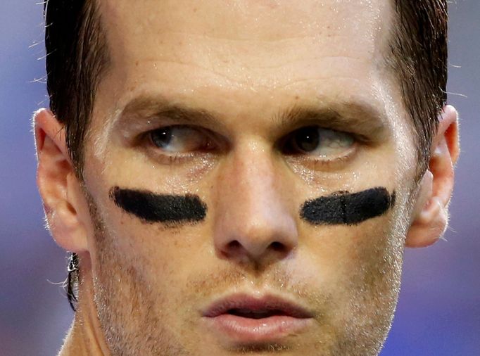 New England Patriots quarterback Tom Brady takes his helmet off during warm-ups ahead of the start of the NFL Super Bowl XLIX football game against the Seattle Seahawks i