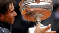 Nadal se kouká na vítěze v odrazu trofeje.