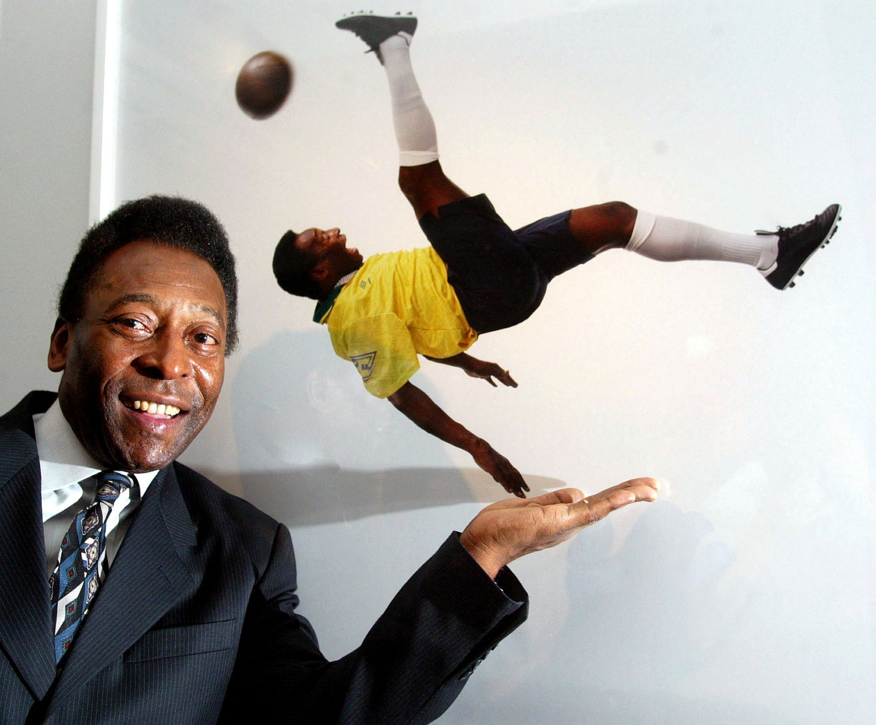 FILE PHOTO: Brazilian soccer legend Pele stands next to a photograph of him by Patrick Lichfield at the opening of the 'Pele Collection' in the County Hall, London