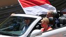 Prince Albert II of Monaco (L) and Princess Charlene are seen in a car with a Monaco flag ahead of the Monaco F1 Grand Prix May 26, 2013. REUTERS/Benoit Tessier (MONACO -