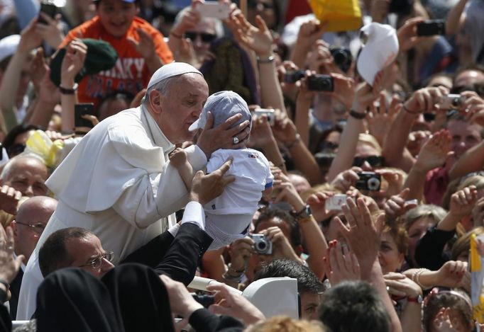 Pope Francis kisses a baby at the end of a canonization mass in Saint Peter's Square at the Vatican May 12, 2013. The Pope led a mass on Sunday for candidates for sainthood Antonio Primaldo, Mother Laura Montoya and Maria Guadalupe Garcia Zavala.