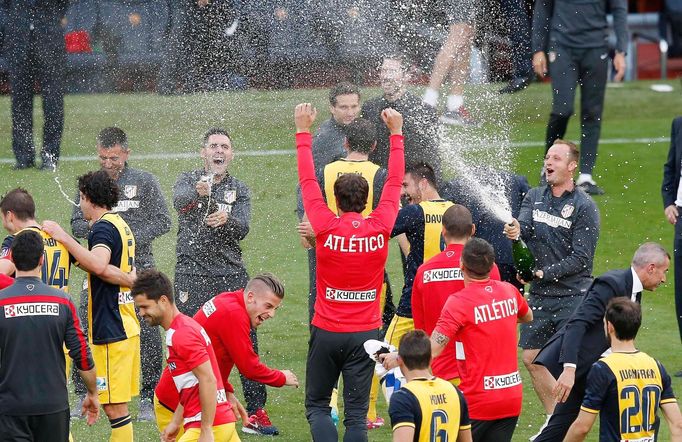 Atletico Madrid's team members celebrate, spraying champagne, after winning their Spanish First Division soccer match against Barcelona, and the league title, in Barcelon