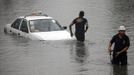 Members of a road emergency group tow a taxi stuck on a flooded street after a heavy downpour in Quezon City, Metro Manila July 3, 2012. Heavy rain has flooded some roads, causing classes to be suspended in parts of Metro Manila, local media reported. REUTERS/Cheryl Ravelo (PHILIPPINES - Tags: ENVIRONMENT TRANSPORT) Published: Čec. 3, 2012, 1:55 dop.