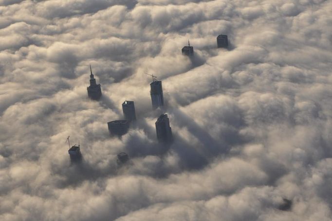 The tops of high rise buildings stick out from a blanket of think fog covering Warsaw early morning October 12, 2012. Picture taken October 12, 2012. REUTERS/Mateusz Olszowy (POLAND - Tags: CITYSPACE ENVIRONMENT TPX IMAGES OF THE DAY) Published: Lis. 21, 2012, 3:44 odp.