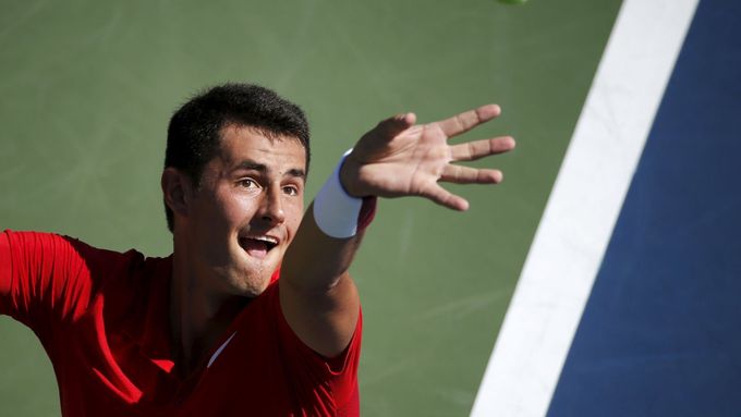 Bernard Tomic of Australia serves to Richard Gasquet of France during their match at the U.S. Open Championships tennis tournament in New York, September 5, 2015. REUTERS