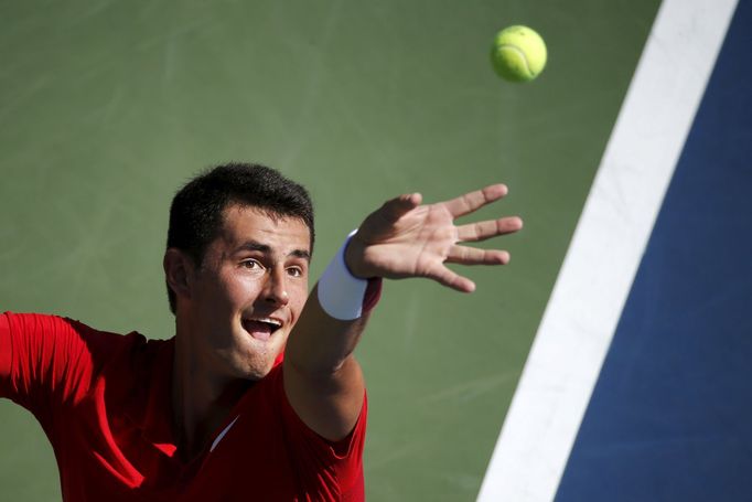 Bernard Tomic of Australia serves to Richard Gasquet of France during their match at the U.S. Open Championships tennis tournament in New York, September 5, 2015. REUTERS